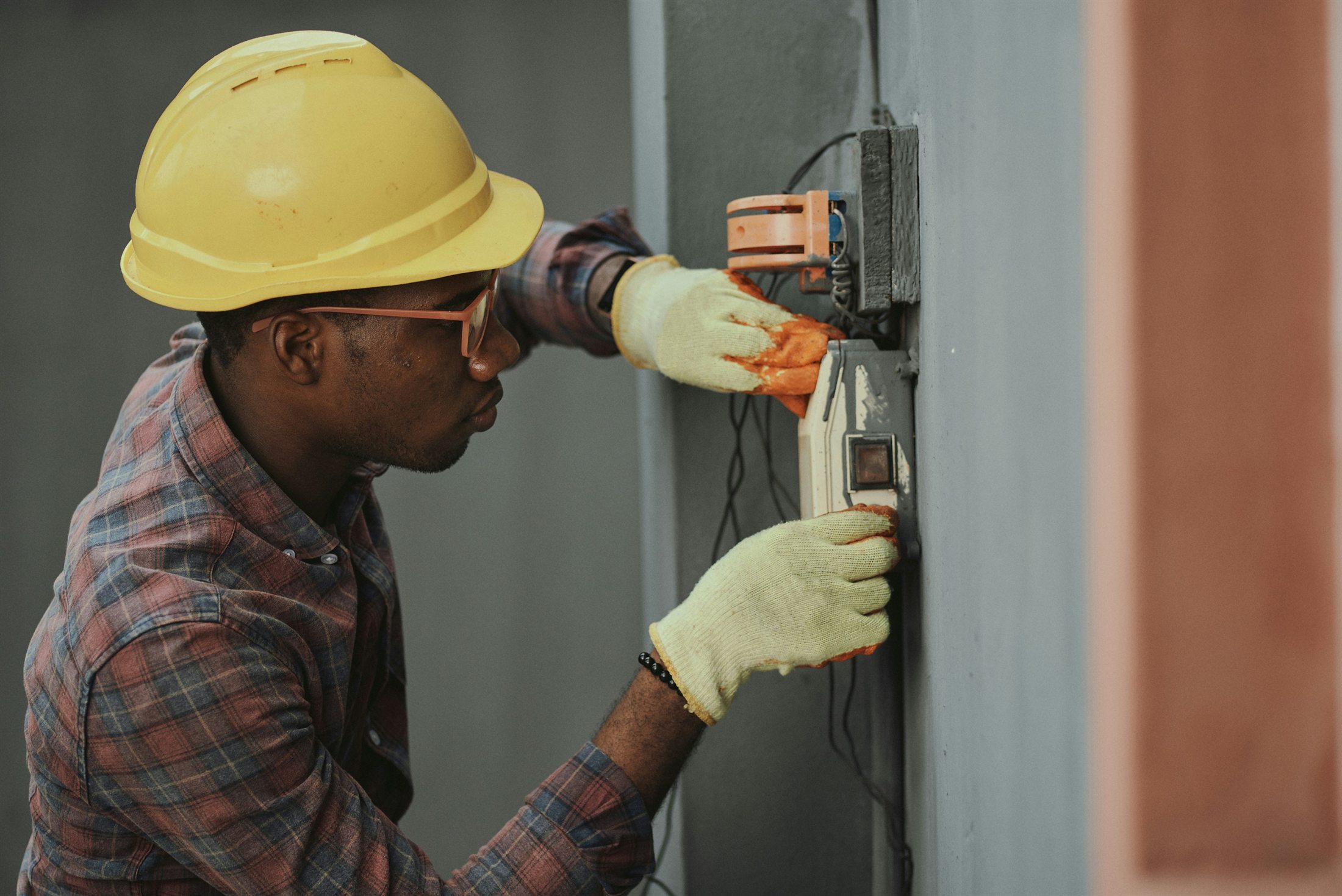 An electrician working on building systems