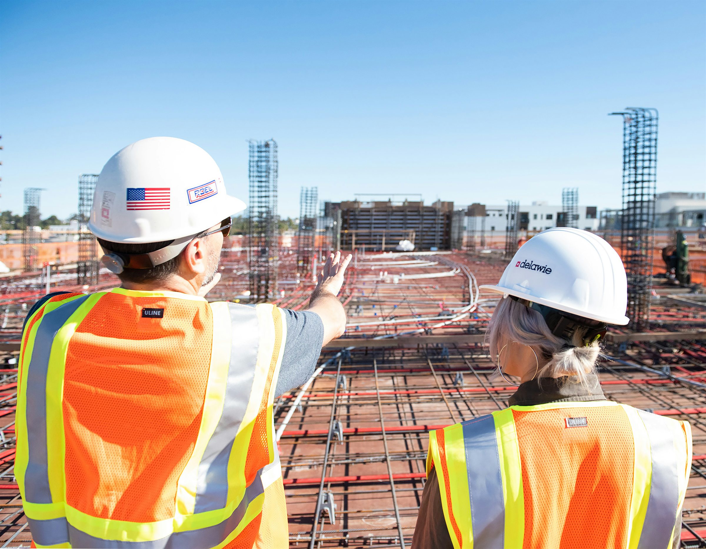 Supervisors reviewing work together on a commercial construction site